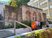 Menschen in Gärtnerbekleidung und Warnbekledung vor einer historischen Treppenanlage